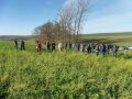 Personen stehen im Halbkreis auf Feld